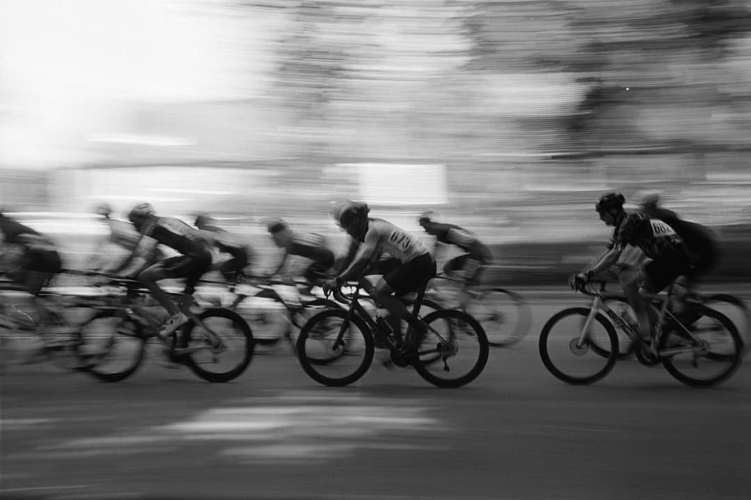 Motion blur of cyclists racing in black and white