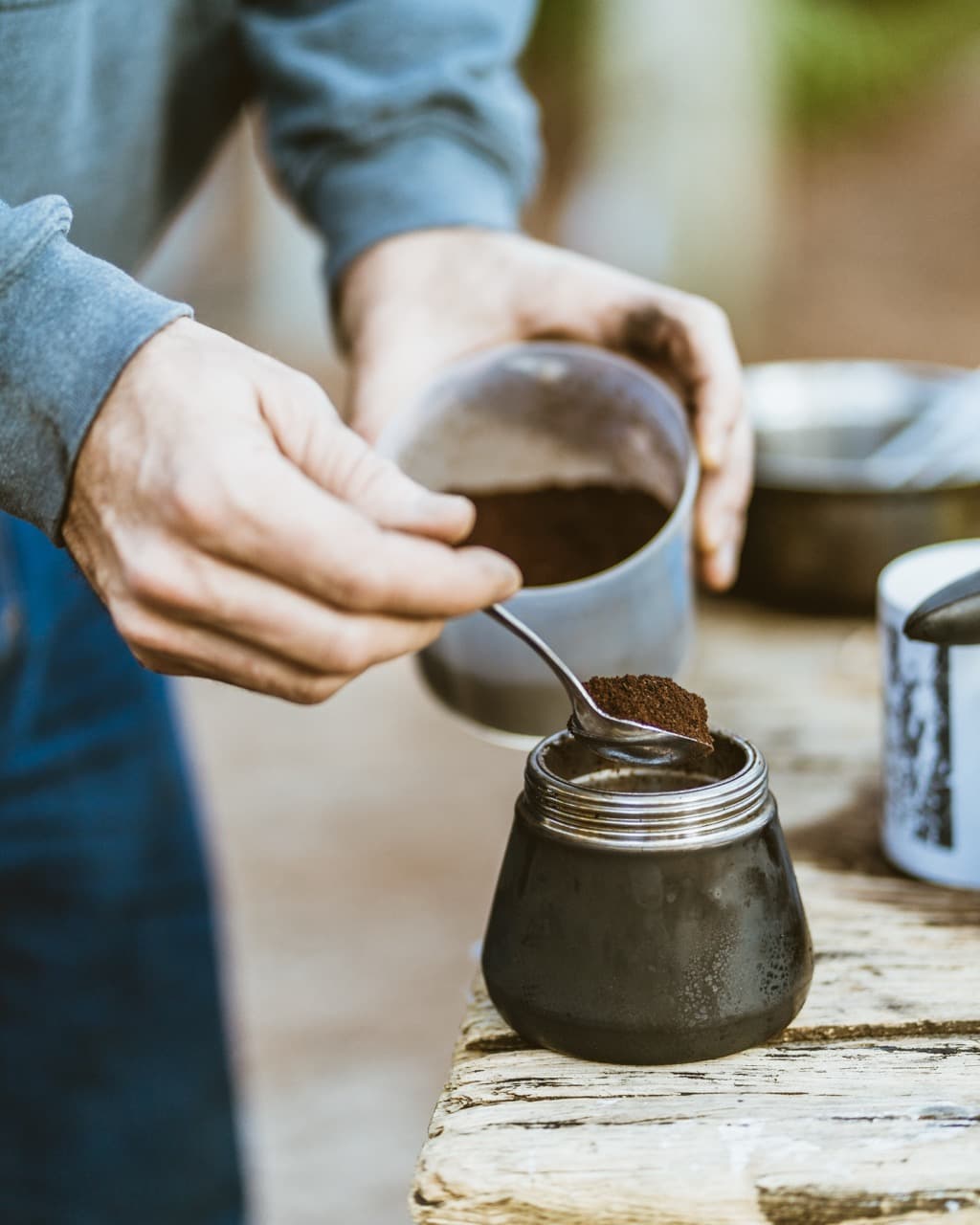 Artisanal coffee brewing process with hand pouring into ceramic vessel