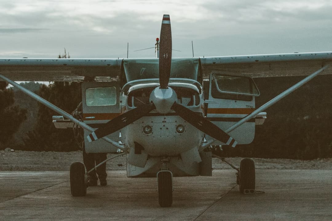 Front view of small aircraft on runway at dawn