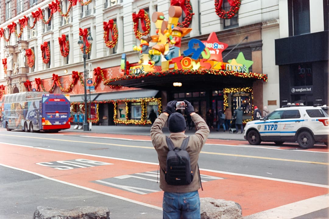 Photographer taking a picture in Times Square, New York City street photography