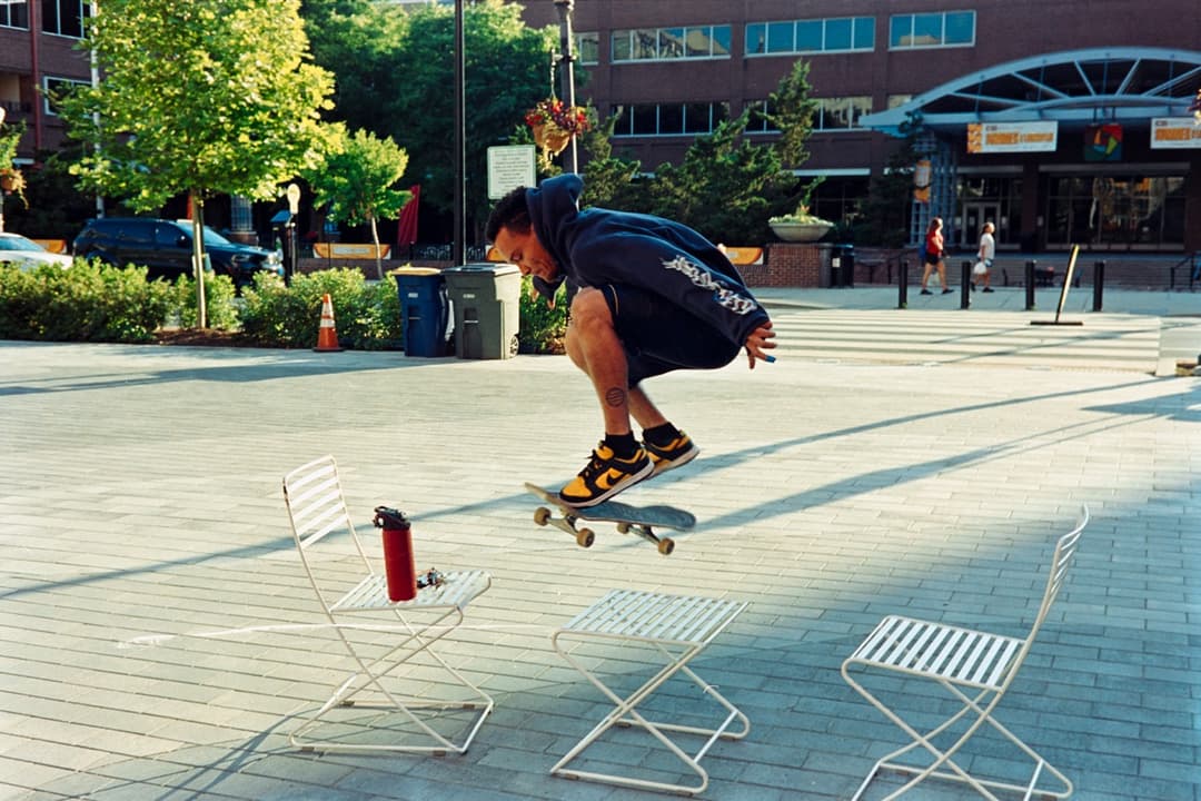 Skateboarder performing a trick in an urban plaza, action sports photography