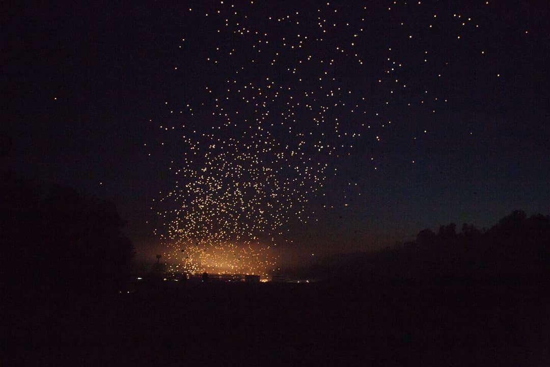 Long exposure of sparks against starry night sky, fireworks display