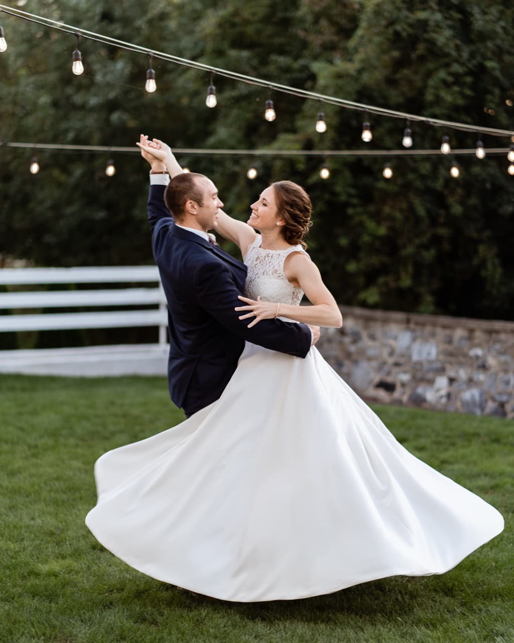 Bride and groom dancing outdoors, romantic wedding moment