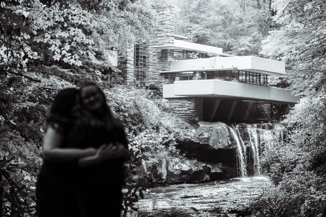 Black and white photo of a couple in front of Fallingwater, architectural wedding photography