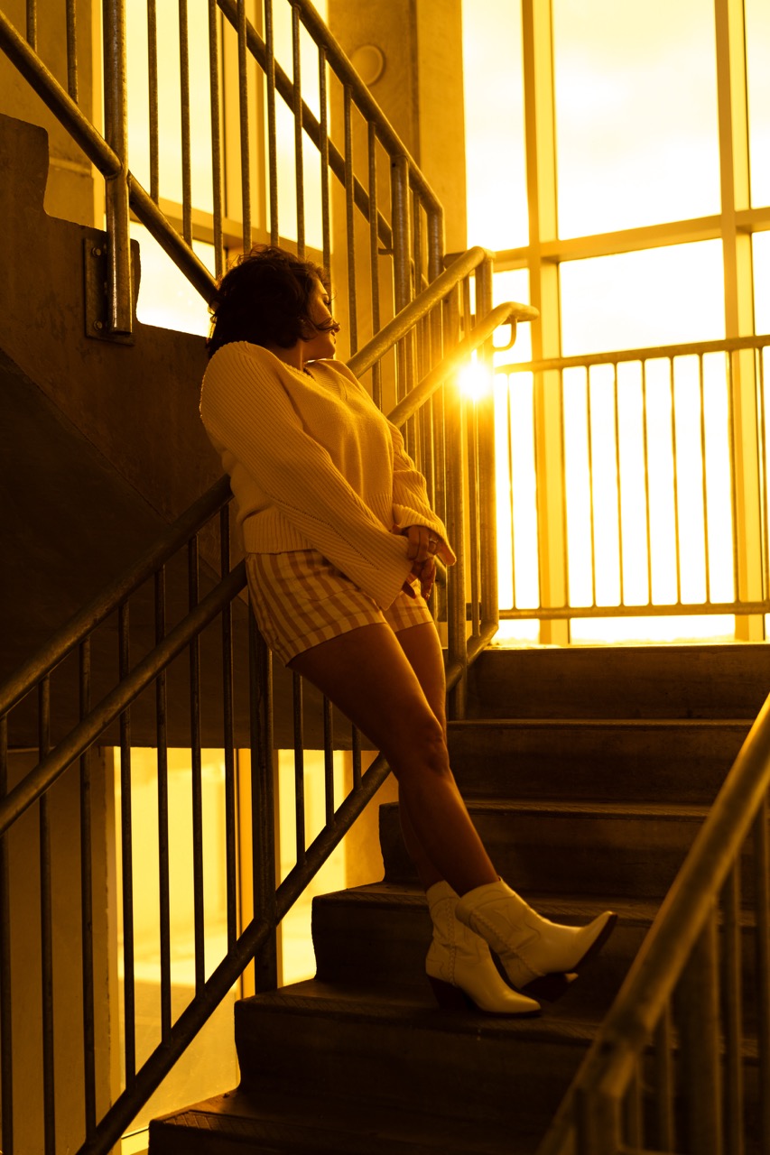 Model in casual pose on industrial staircase