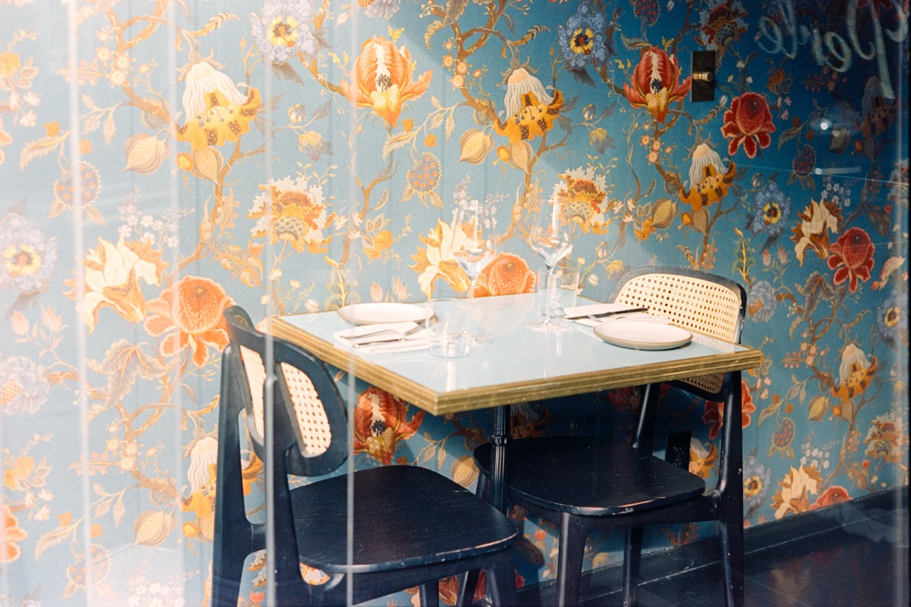 Vintage cafe interior with floral wallpaper