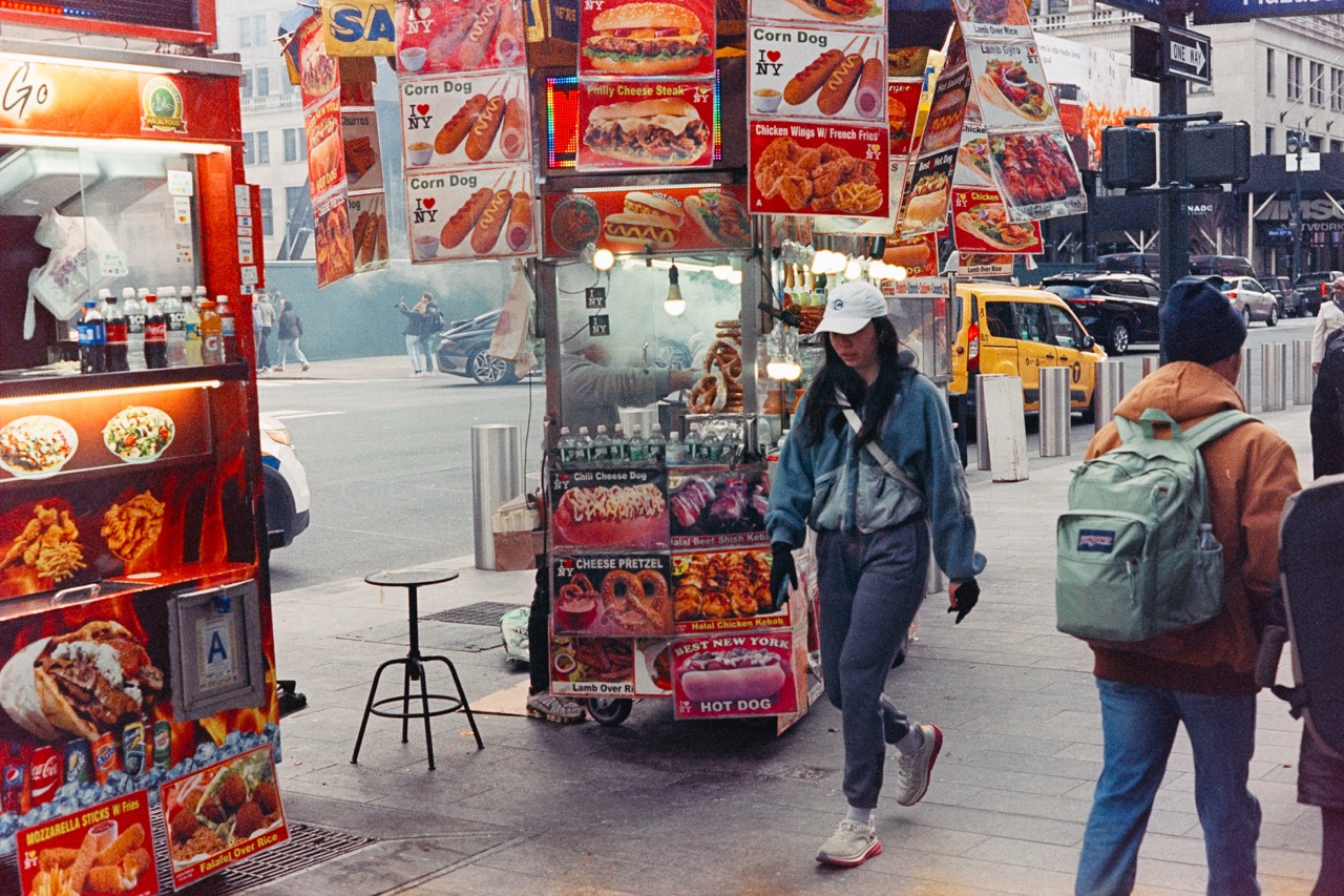 Street food vendor with colorful menu displays