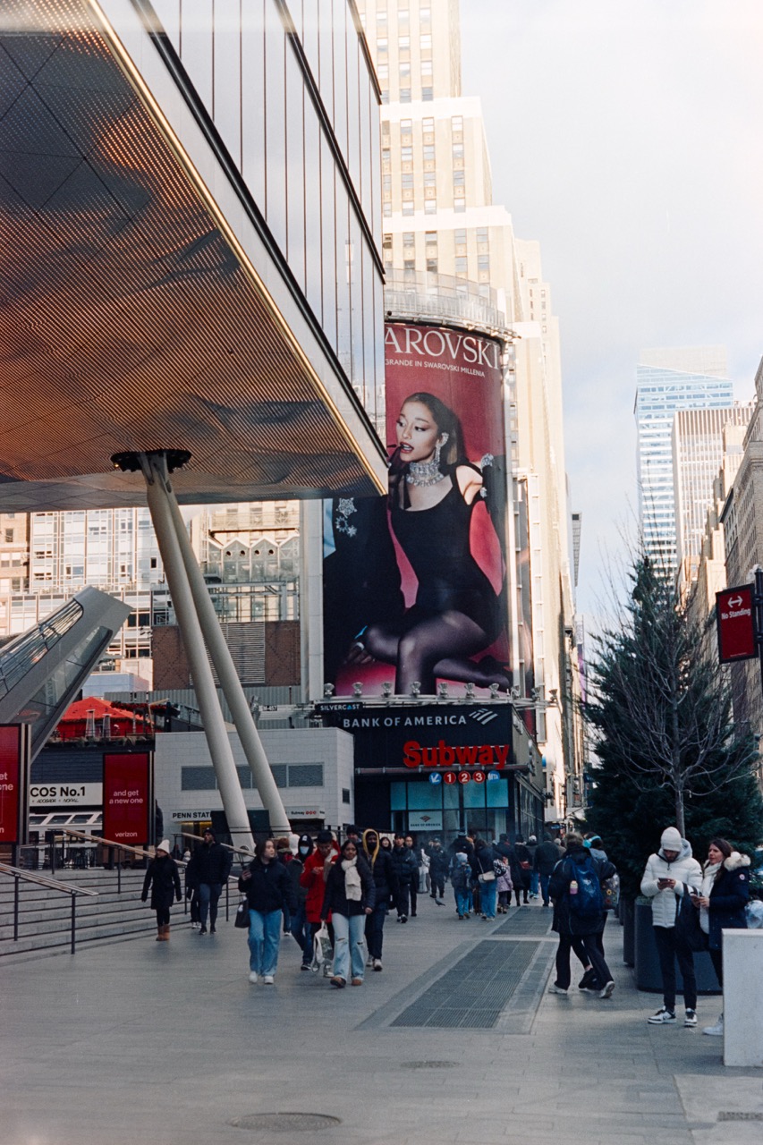 Street scene with billboard and pedestrians