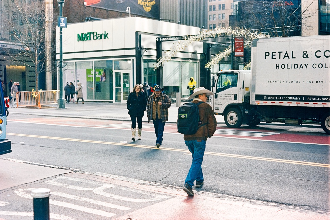 Urban street scene with pedestrians and retail stores